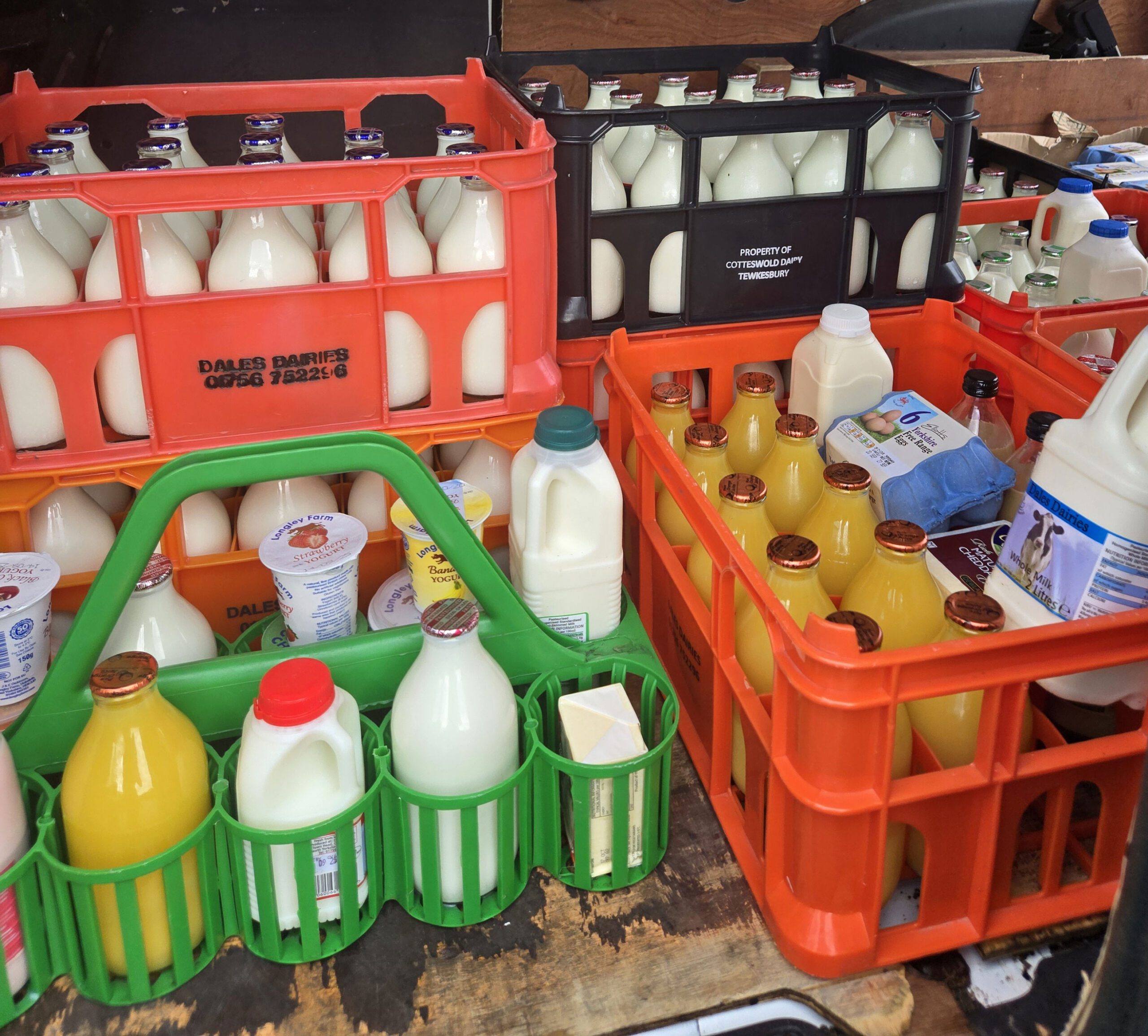 Crates of fresh milk, juice, and dairy products ready for doorstep delivery in York.<br />
